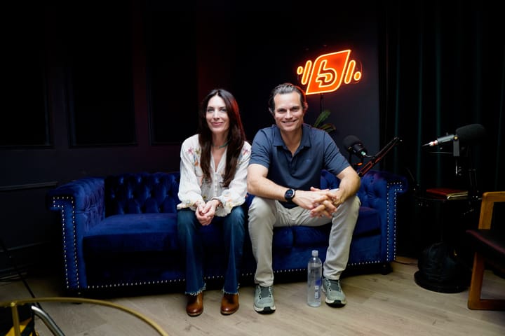 Scott Elrod next to Cosper on a blue velvet couch in studio talking shop, cars, and making it big in the City of Angels.
